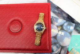 A Lady's 18ct yellow gold diamond set Rolex oyster perpetual datejust wristwatch, with a blue dial,