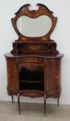 A 19th century mahogany chiffonier, the shield shaped upstand with a central mirror and shelf,