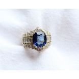 A sapphire and diamond ring, the central oval sapphire approximately 11mm x 9mm,