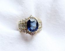 A sapphire and diamond ring, the central oval sapphire approximately 11mm x 9mm,