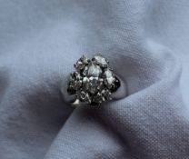 A diamond ring set with seven marquise shaped diamonds,