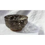 A Chinese white metal bowl with pierced decoration of chrysanthemums and leaves on a spreading foot,