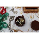 A large collection of costume jewellery, including yellow metal necklaces, bead necklaces,