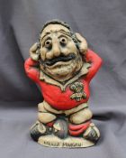 A John Hughes pottery Grogg titled "Mauler Morgan", in a Welsh jersey with his arms behind his head,
