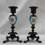 A pair of continental porcelain and bronze candlestick, with a flared sconce,