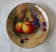 A Royal Worcester porcelain side plate painted with apples and blackberries to a naturalistic