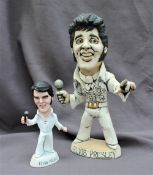 A John Hughes pottery Grogg of Elvis Presley, in white suit holding a microphone,