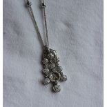 A diamond necklace set with baguette and brilliant cut diamonds to a white metal setting and chain