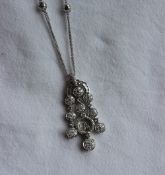 A diamond necklace set with baguette and brilliant cut diamonds to a white metal setting and chain