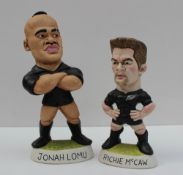 A World of Groggs resin model of Jonah Lomu in a black jersey with arms folded and number 11 on the
