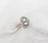 A diamond dress ring, set with two round old cut diamonds each approximately 0.