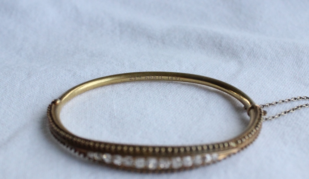 A Victorian diamond set hinged bangle set with thirteen round old cut diamonds to a yellow metal - Image 2 of 4