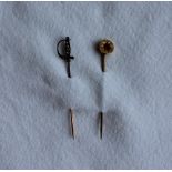 A diamond set sabre stick pin set with rose cut diamonds to a yellow metal shank together with