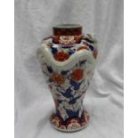 A Japanese porcelain vase with a relief moulded dragon,