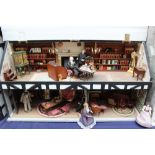 Dolls House - A long house, the hinged slate roof opening to reveal a library with bookcases,