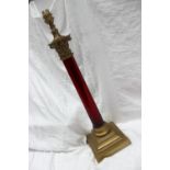 A cranberry glass and brass table lamp,