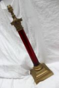 A cranberry glass and brass table lamp,