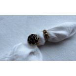 A 9ct yellow gold garnet set dress ring, set with a central oval garnet,