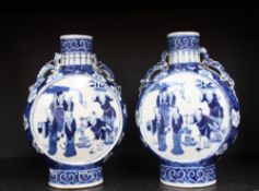 A pair of Chinese blue and white porcelain moon flasks, decorated with figures, with dragon handles,