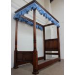 A 20th century oak four poster single bed, the canopy with a moulded cornice,