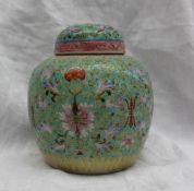 A Chinese famille verte porcelain ginger jar and cover, decorated with flower heads,