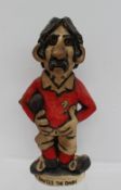 A John Hughes pottery Grogg titled "David the Dash" in a red Welsh jersey with No.