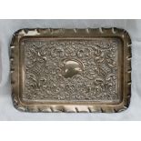 An Edward VII silver dressing table tray of rectangular form, embossed with scrolls and leaves,