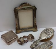 An Edward VII silver photograph frame, Birmingham, 1906 together with a silver cigarette box,