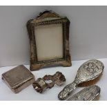 An Edward VII silver photograph frame, Birmingham, 1906 together with a silver cigarette box,