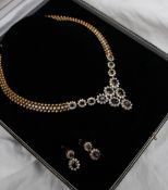 An 18ct yellow gold sapphire and diamond necklace set with twenty two round brilliant cut diamonds