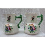 A pair of Dillwyn Swansea pottery jugs, decorated with flowerheads and leaves to a panelled body,