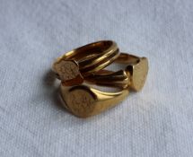 An 18ct yellow gold signet ring of shield shape, together with two other 18ct yellow gold rings,