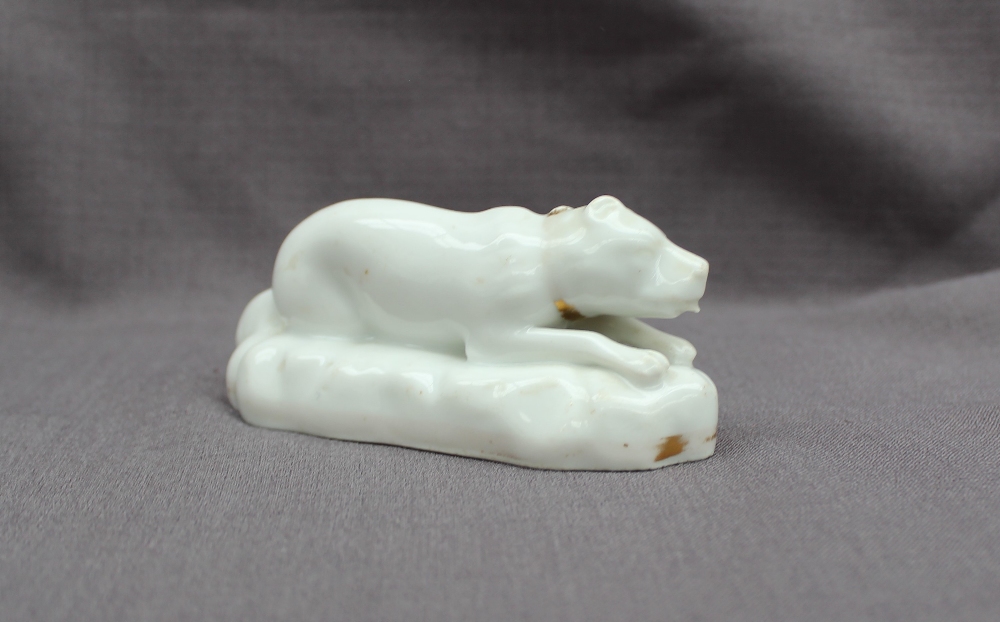 A 19th century porcelain figure of a reclining dog on an oval base, - Image 2 of 3