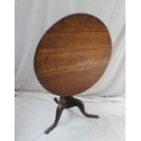 A 19th century oak tripod table,