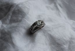 A diamond dress ring, the central round brilliant cut stone approximately 1.