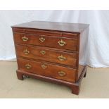 A George III style mahogany chest the rectangular planked top above a brushing slide and three