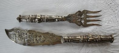 A pair of Victorian silver fish servers, with a pierced blade and cast handles, Birmingham, 1869,