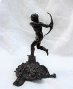 A bronze model of Cupid with his bow drawn and quiver on his hip, on a floral scrolling base, 16.