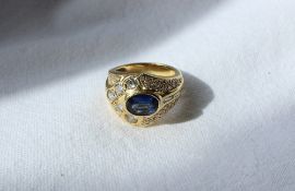 A sapphire and diamond ring, the central oval sapphire approximately 9mm x 6mm,