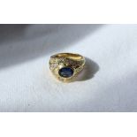 A sapphire and diamond ring, the central oval sapphire approximately 9mm x 6mm,