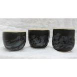 Studio pottery by Barbara Ineson - A set of three pottery vases with a black body and abstract