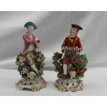 A pair of 18th century porcelain figures, possibly Bow, the one squeezing grapes into a chalice,