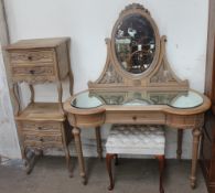 A limed oak dressing table together with a pair of limed oak bedsides cabinets and an upholstered