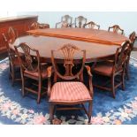 A large circular reproduction mahogany dining table and twelve dining chairs with wheat sheaf