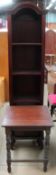 An Indonesian hardwood bookcase together with an occasional table