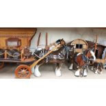 A collection of pottery shire horses pulling gypsy caravans and drays,