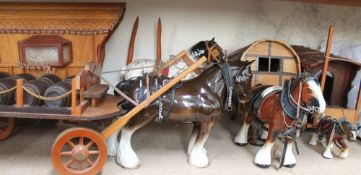 A collection of pottery shire horses pulling gypsy caravans and drays,