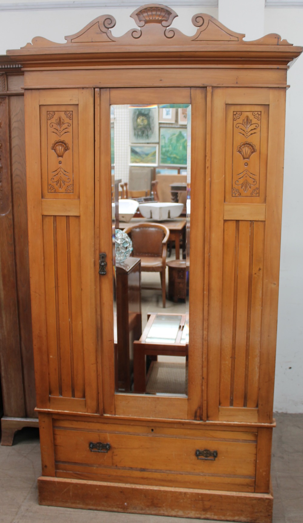 An Edwardian satin walnut wardrobe with a mirrored door