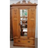 An Edwardian satin walnut wardrobe with a mirrored door