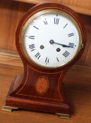 A 20th century mahogany balloon shaped mantle clock, the enamel dial with Roman numerals,